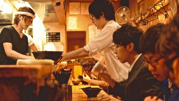 Japanese men eating noodles at a restaurant