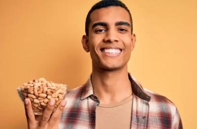 Man holding a bowl of peanuts