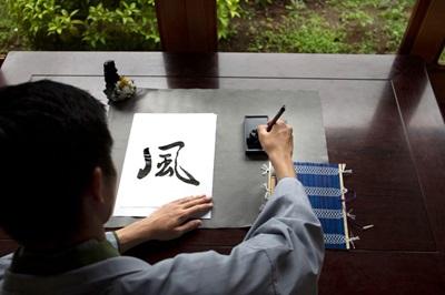 Person writing calligraphy