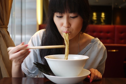 Woman slurping noodles