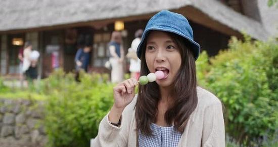 Woman eating Dango