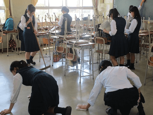 Japanese school children cleaning the gymnasium floors