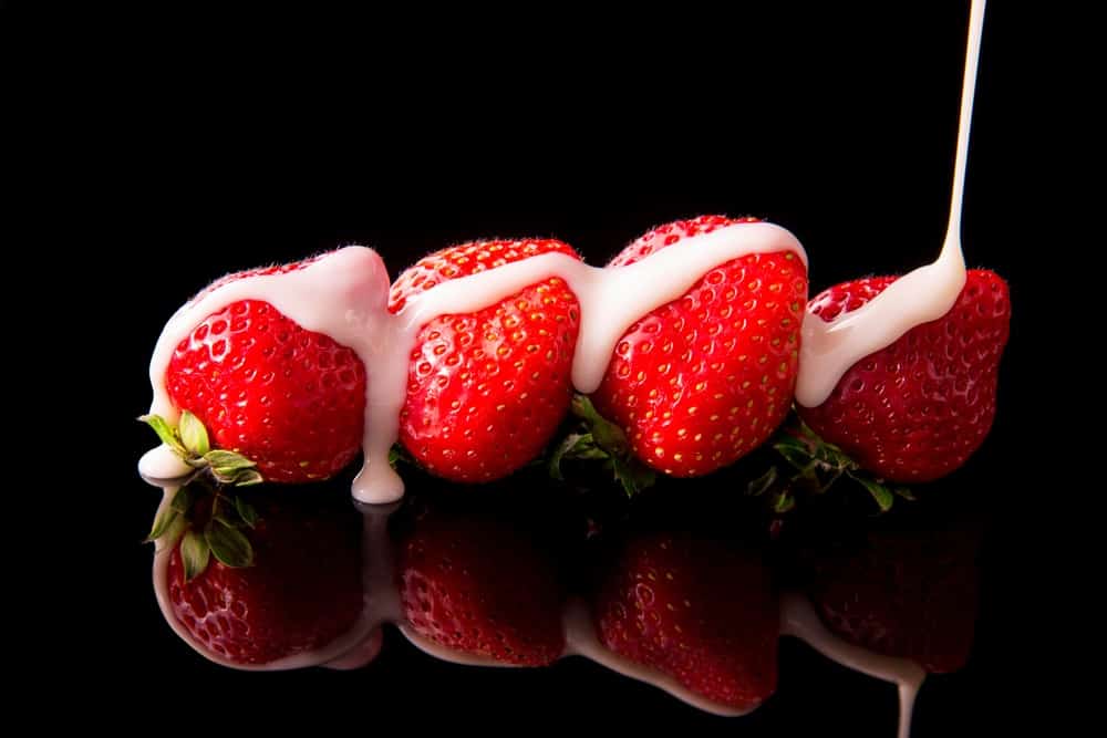 Strawberries covered in a drizzle of condensed milk